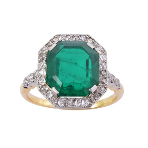 Early 20th century emerald and diamond cluster ring, c.1910, the cut-corner rectangular 4.44ct Colombian emerald,